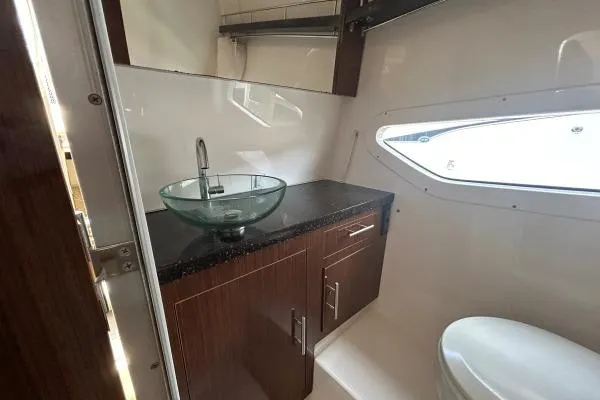 Qtech-1 Yacht Photos Pics Luxurious bathroom in 2015 Regal 32 Express yacht with modern sink and sleek cabinetry.