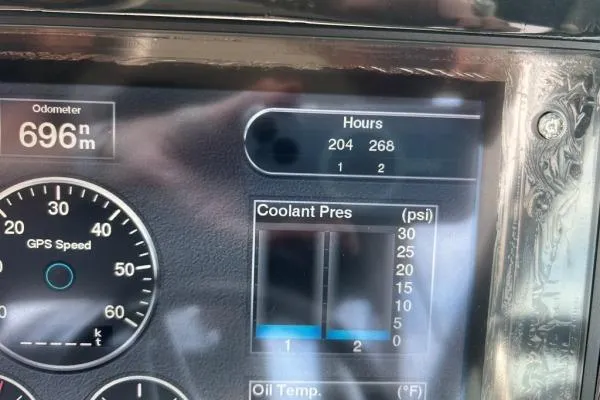 Qtech-1 Yacht Photos Pics Dashboard of a 2015 Regal 32 Express showing odometer, engine hours, and coolant pressure.