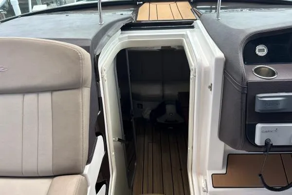 Qtech-1 Yacht Photos Pics 2015 Regal 32 Express boat interior with open cabin door and seating area.