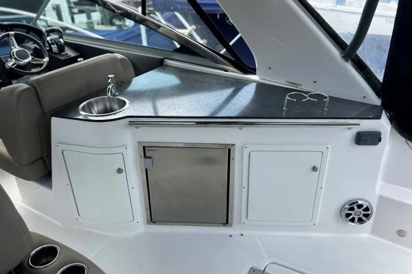 Qtech-1 Yacht Photos Pics 2015 Regal 32 Express boat interior with sink and storage cabinets.