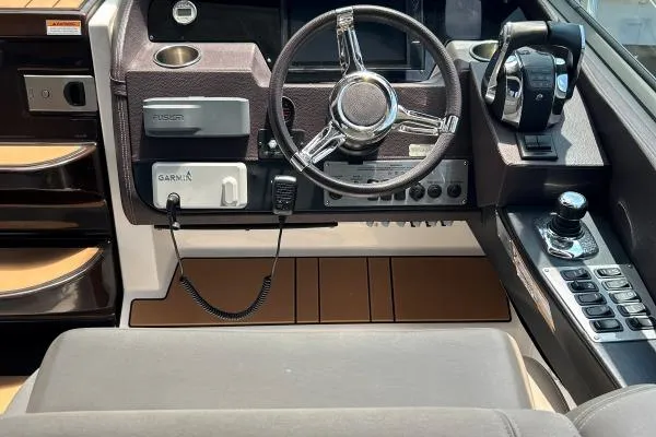 Qtech-1 Yacht Photos Pics Cockpit of 2015 Regal 32 Express boat with steering wheel and navigation controls.