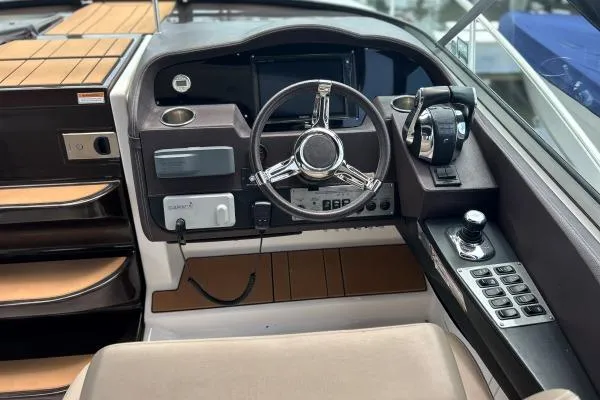 Qtech-1 Yacht Photos Pics 2015 Regal 32 Express boat cockpit with steering wheel and control panel.