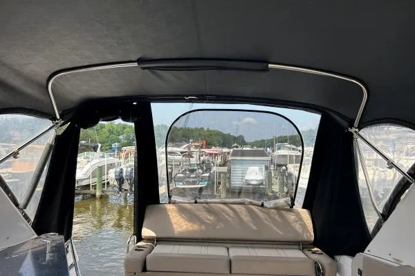 Qtech-1 Yacht Photos Pics 2015 Regal 32 Express boat interior with marina view through rear canopy.