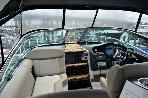 Qtech-1 Yacht Photos Pics 2015 Regal 32 Express boat interior with helm, seating, and dashboard.