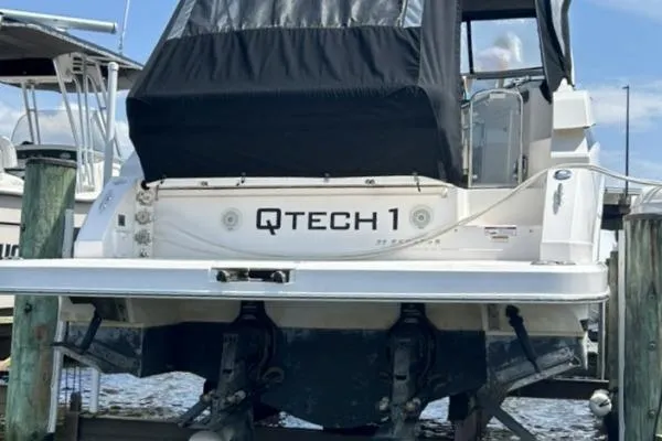 Qtech-1 Yacht Photos Pics 2015 Regal 32 Express boat docked, rear view with "QTECH 1" name visible.