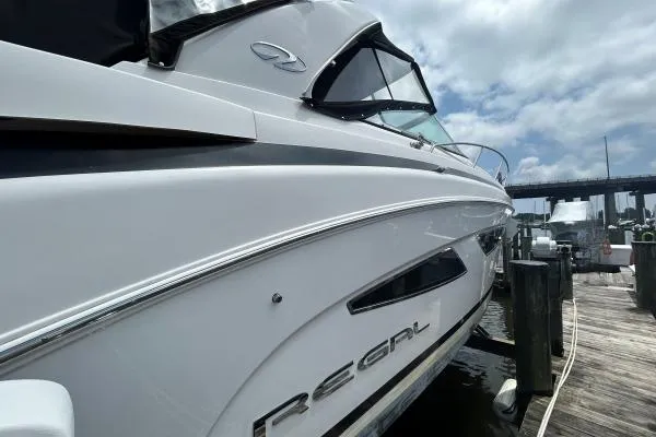 Qtech-1 Yacht Photos Pics 2015 Regal 32 Express boat docked, showcasing sleek design and modern features.