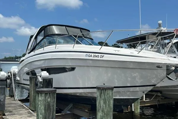 Qtech-1 Yacht Photos Pics 2015 Regal 32 Express boat docked at marina under clear blue sky.