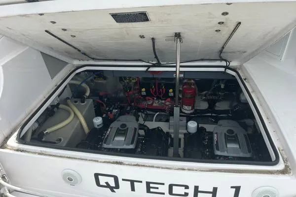 Qtech-1 Yacht Photos Pics Engine compartment of a 2015 Regal 32 Express boat, showcasing dual engines and equipment.