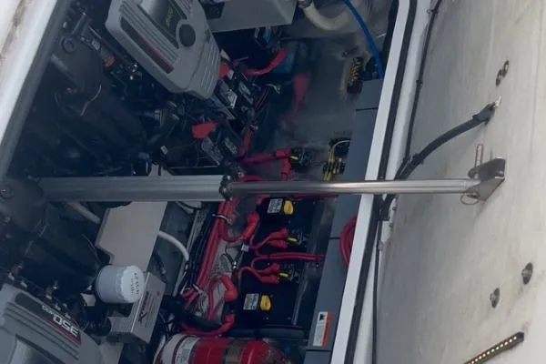 Qtech-1 Yacht Photos Pics Engine compartment of a 2015 Regal 32 Express boat, showcasing mechanical components.