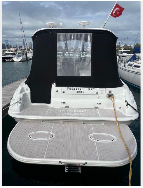 Larson 370 boat from 2004 docked at marina with Turkish flag.