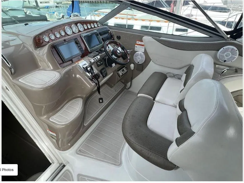 2004 Larson 370 boat cockpit with dual seats, modern controls, and navigation displays.
