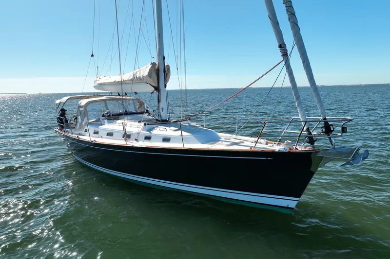 Munequita Yacht Photos Pics Sailing yacht Tartan 4000, 2013 model, cruising on open water under clear skies.