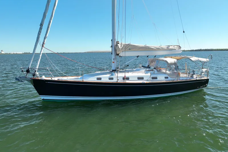 Munequita Yacht Photos Pics Sailboat on water, 2013 Tartan 4000 model, clear sky, calm sea.