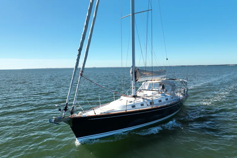 Munequita Yacht Photos Pics Sailing yacht Tartan 4000, 2013 model, cruising on open water under clear blue skies.