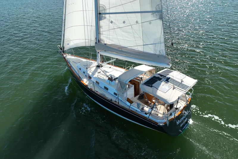 Munequita Yacht Photos Pics Sailing yacht Tartan 4000 (2013) gliding on open water with full sails.