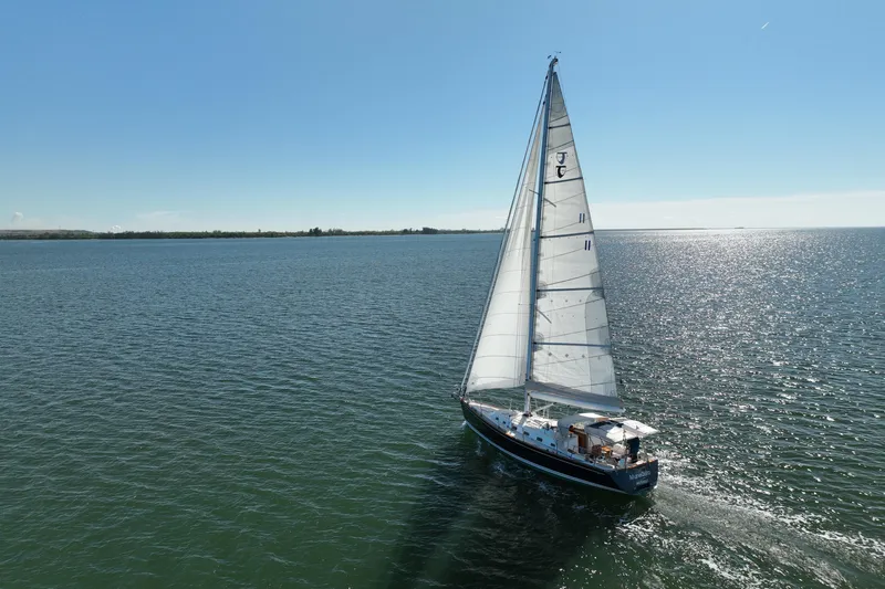 Munequita Yacht Photos Pics Sailboat Tartan 4000 (2013) gliding on a sunny, tranquil sea.