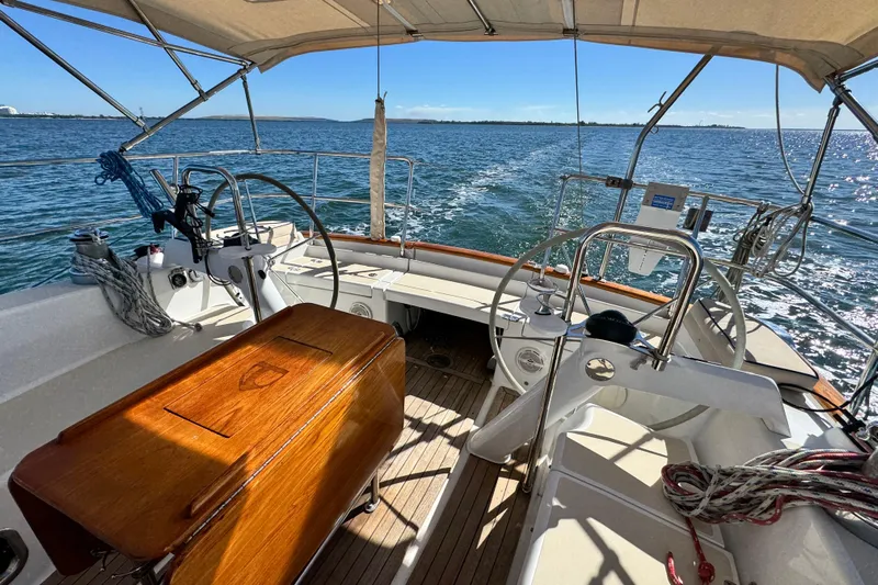 Munequita Yacht Photos Pics Cockpit view of 2013 Tartan 4000 sailboat on open water, sunny day.