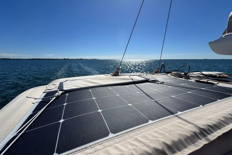 Munequita Yacht Photos Pics Sailboat with solar panels on deck, Tartan 4000, 2013 model, cruising on sunny ocean.