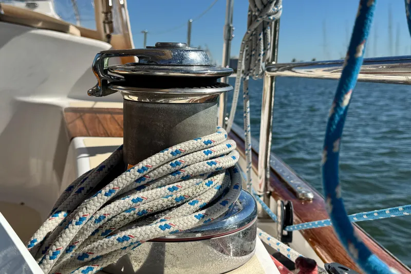 Munequita Yacht Photos Pics Winch on 2013 Tartan 4000 sailboat with ropes, docked by the water.