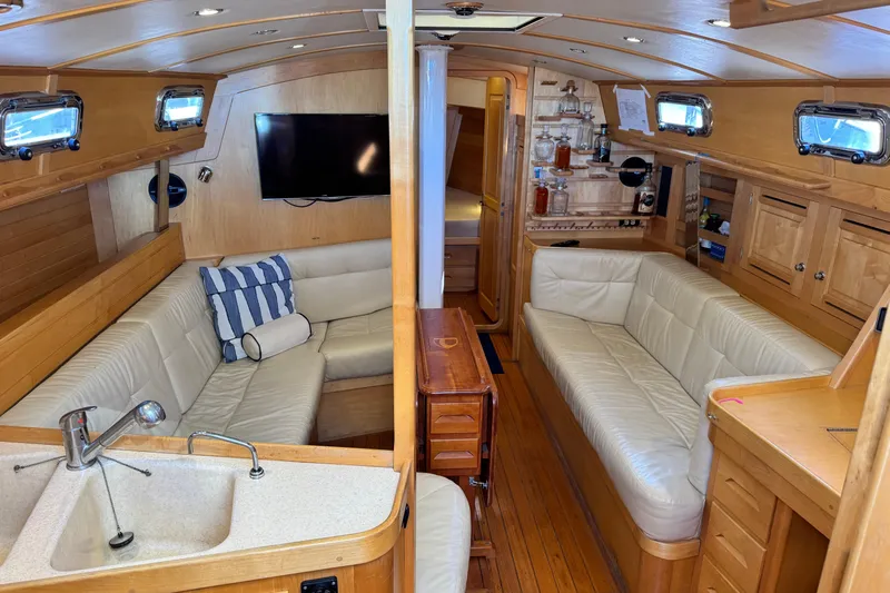 Munequita Yacht Photos Pics Luxurious interior of a 2013 Tartan 4000 yacht with leather seating and wooden finishes.