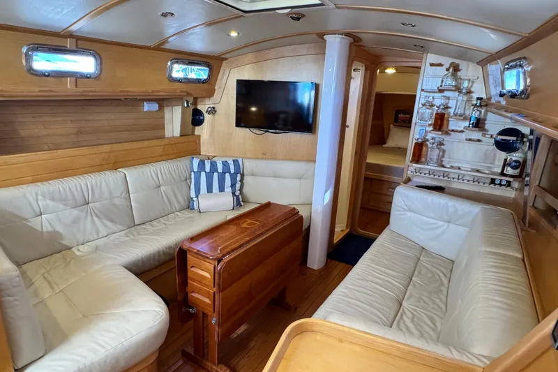 Munequita Yacht Photos Pics Luxurious interior of 2013 Tartan 4000 yacht with leather seating and wooden accents.