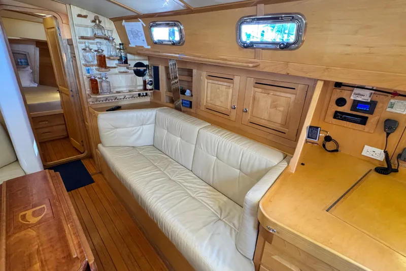 Munequita Yacht Photos Pics Luxurious 2013 Tartan 4000 yacht interior with white leather sofa and wooden cabinetry.