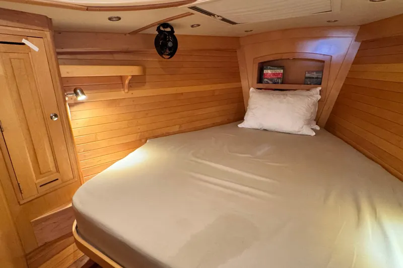 Munequita Yacht Photos Pics Cozy cabin interior of 2013 Tartan 4000 sailboat with wooden paneling and comfortable bedding.