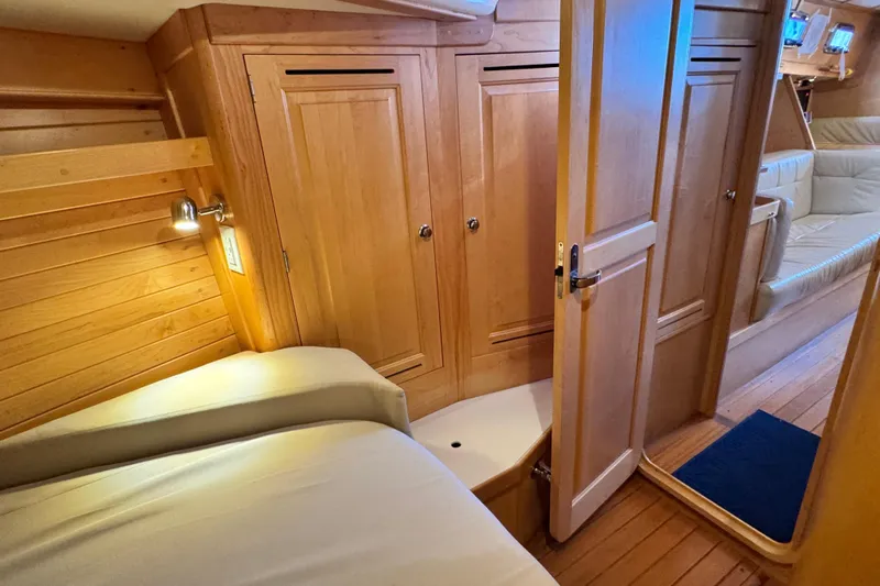Munequita Yacht Photos Pics Interior of 2013 Tartan 4000 yacht with wooden cabinetry and cozy seating area.