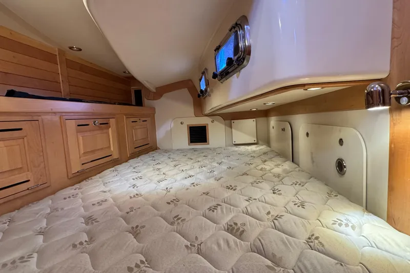 Munequita Yacht Photos Pics Cozy cabin interior of 2013 Tartan 4000 sailboat with wood cabinetry and porthole window.