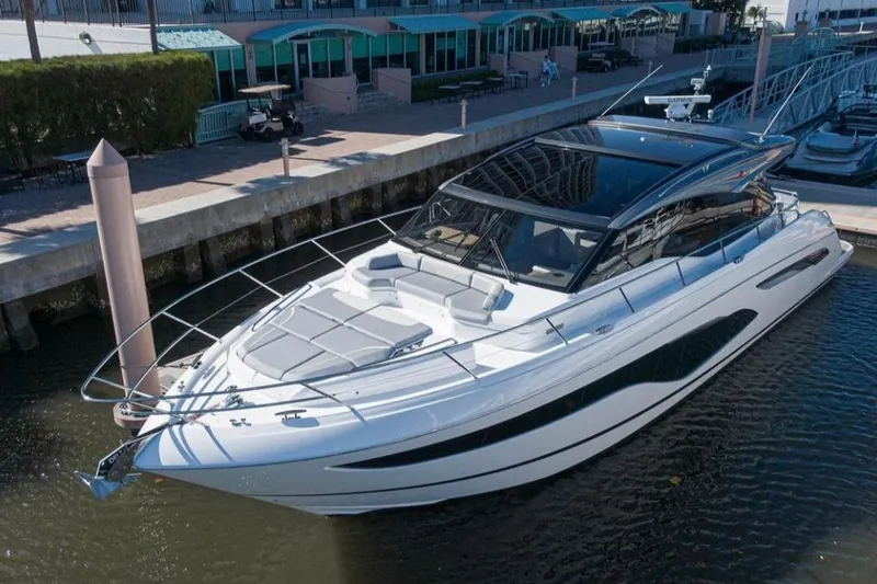  Yacht Photos Pics Luxurious 2019 Princess V60 yacht docked at a marina, showcasing sleek design.