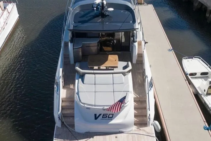  Yacht Photos Pics 2019 Princess V60 yacht docked, rear view with American flag and spacious deck.