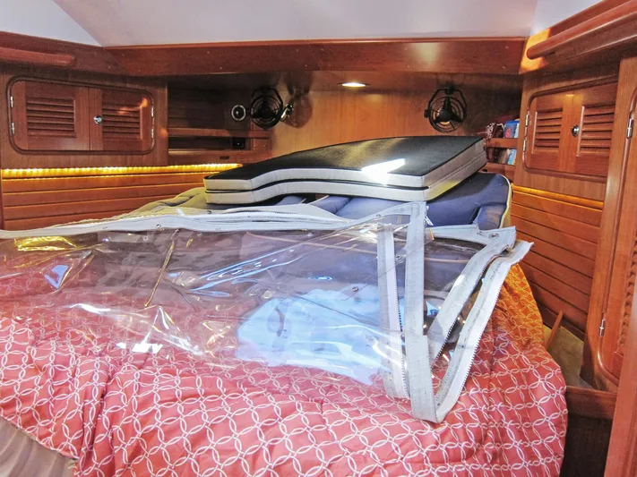 Solitude Yacht Photos Pics Cozy cabin interior of 2018 Passport 545 yacht with wooden paneling and bedding.