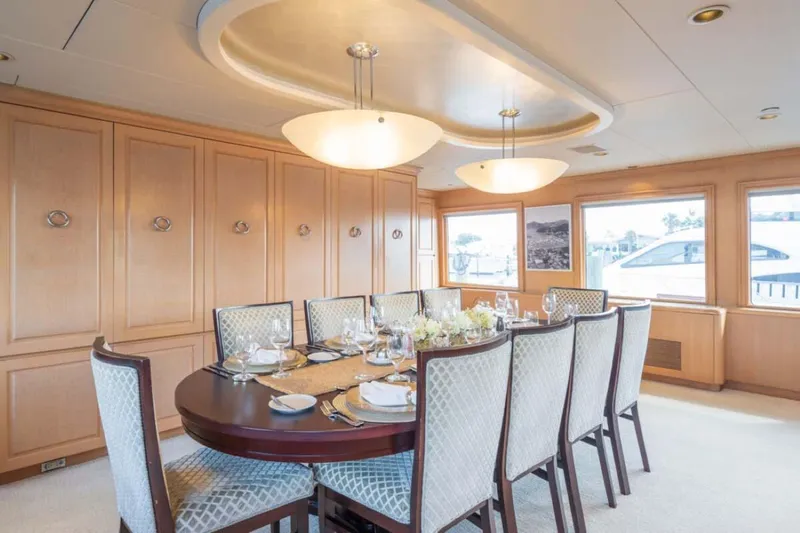 Chanson Yacht Photos Pics Luxurious dining area on 1995 Christensen Tri-Deck yacht with elegant table setting.