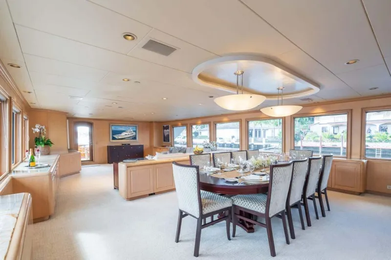 Chanson Yacht Photos Pics Luxurious dining area on 1995 Christensen Tri-Deck yacht, featuring elegant decor and large windows.