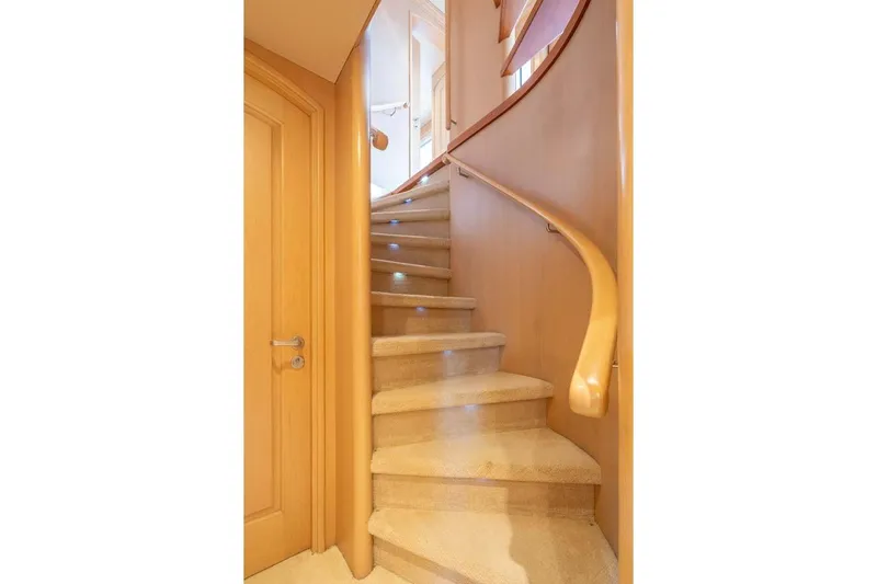 Chanson Yacht Photos Pics Curved staircase with wooden handrail on 1995 Christensen Tri-Deck yacht.