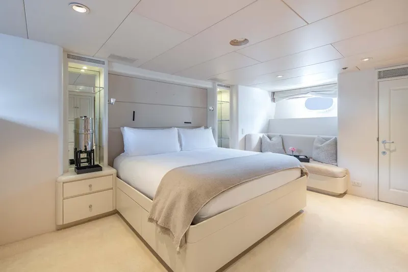Chanson Yacht Photos Pics Luxurious bedroom on 1995 Christensen Tri-Deck yacht with elegant decor and cozy seating area.