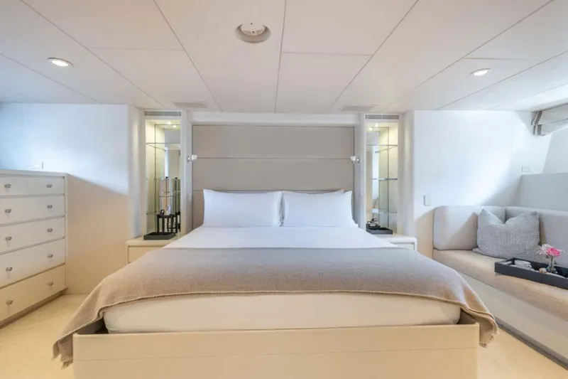 Chanson Yacht Photos Pics Luxurious bedroom interior on 1995 Christensen Tri-Deck yacht, featuring elegant decor and cozy seating.