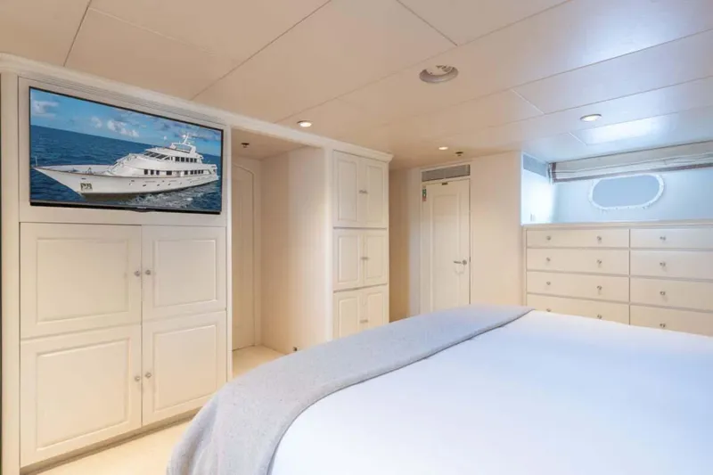 Chanson Yacht Photos Pics Luxurious bedroom interior on 1995 Christensen Tri-Deck yacht with elegant white cabinetry.