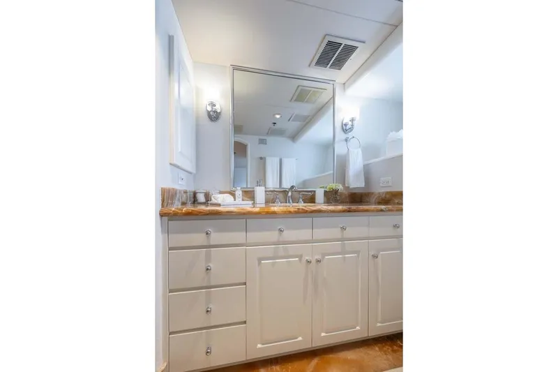 Chanson Yacht Photos Pics Luxurious bathroom vanity on 1995 Christensen Tri-Deck yacht, featuring elegant cabinetry and marble countertop.