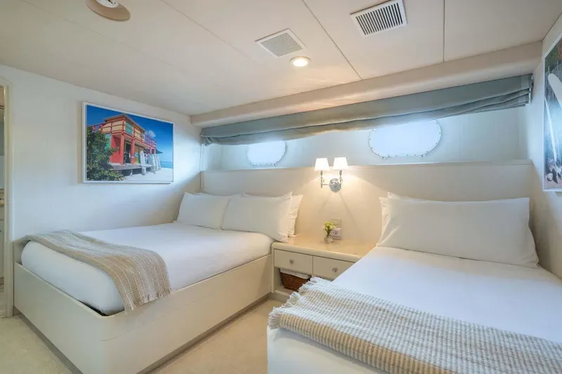 Chanson Yacht Photos Pics Luxurious bedroom on 1995 Christensen Tri-Deck yacht with twin beds and elegant decor.