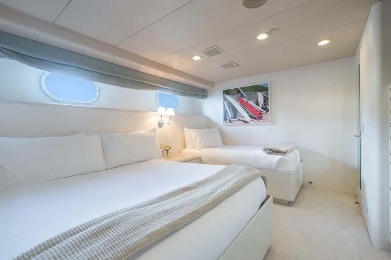 Chanson Yacht Photos Pics Luxurious bedroom interior on a 1995 Christensen Tri-Deck yacht, featuring twin beds and elegant decor.