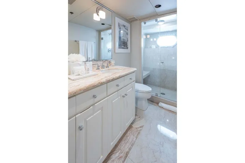 Chanson Yacht Photos Pics Luxurious bathroom on 1995 Christensen Tri-Deck yacht with marble countertops and glass shower.