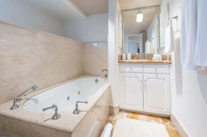 Chanson Yacht Photos Pics Luxurious bathroom with marble jacuzzi tub and elegant vanity on Christensen Tri-Deck yacht, 1995.