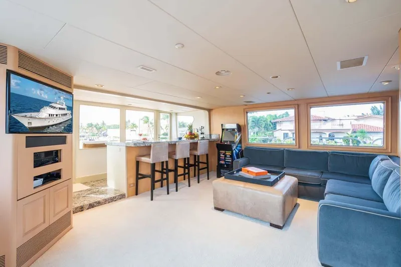 Chanson Yacht Photos Pics Luxurious 1995 Christensen Tri-Deck yacht interior with modern lounge and bar area.