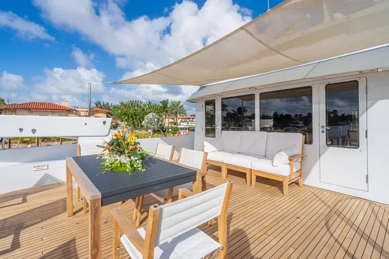 Chanson Yacht Photos Pics Luxurious 1995 Christensen Tri-Deck yacht deck with elegant seating and dining area.