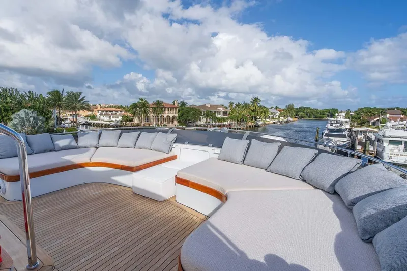 Chanson Yacht Photos Pics Luxurious 1995 Christensen Tri-Deck yacht with spacious deck seating and scenic waterfront view.