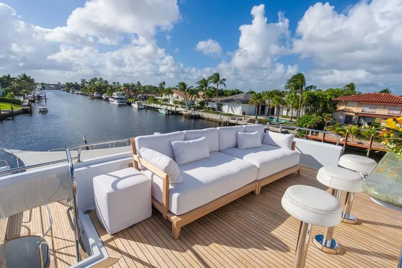 Chanson Yacht Photos Pics Luxurious 1995 Christensen Tri-Deck yacht deck with plush seating, overlooking serene waterfront views.