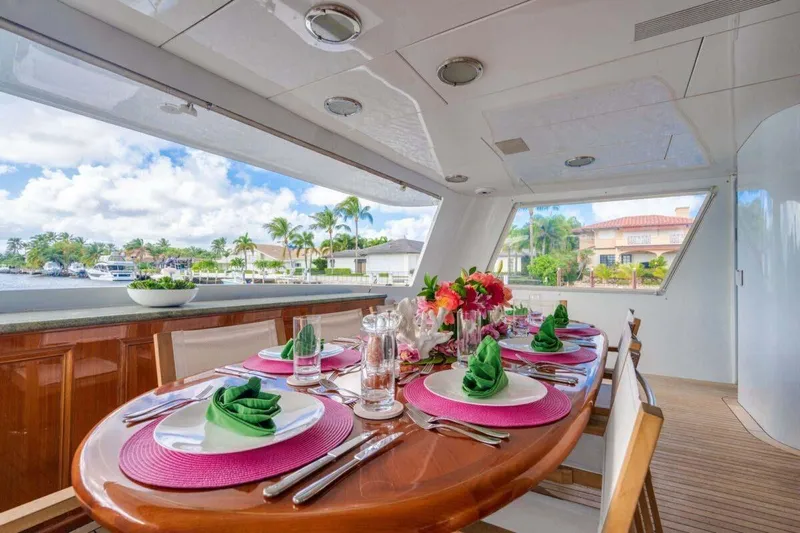 Chanson Yacht Photos Pics Luxurious dining setup on 1995 Christensen Tri-Deck yacht with waterfront view.