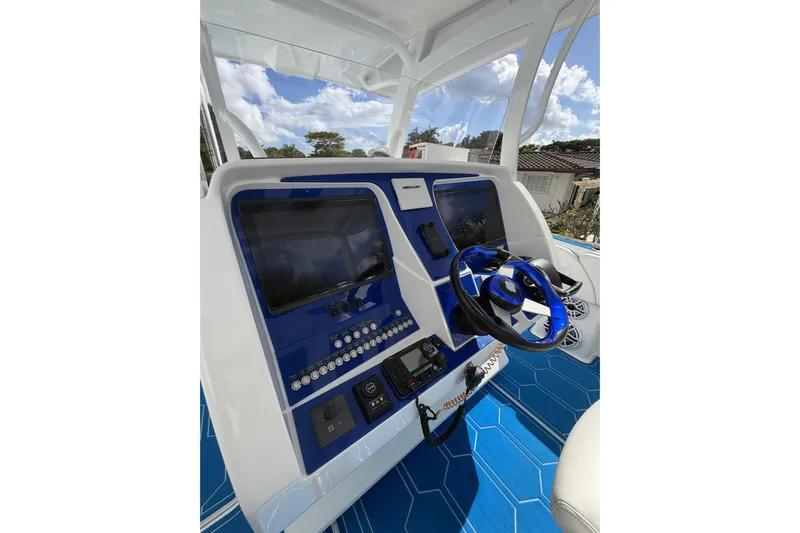  Yacht Photos Pics 2012 Deep Impact 399 Sport boat dashboard with blue accents and modern controls.
