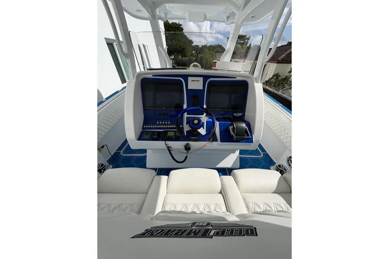  Yacht Photos Pics 2012 Deep Impact 399 Sport boat cockpit with modern controls and white seating.